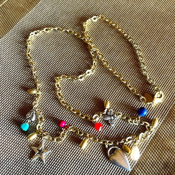 Chico's Jewelry - Chico’s long gold tone necklace with whimsical charms. NWOT
